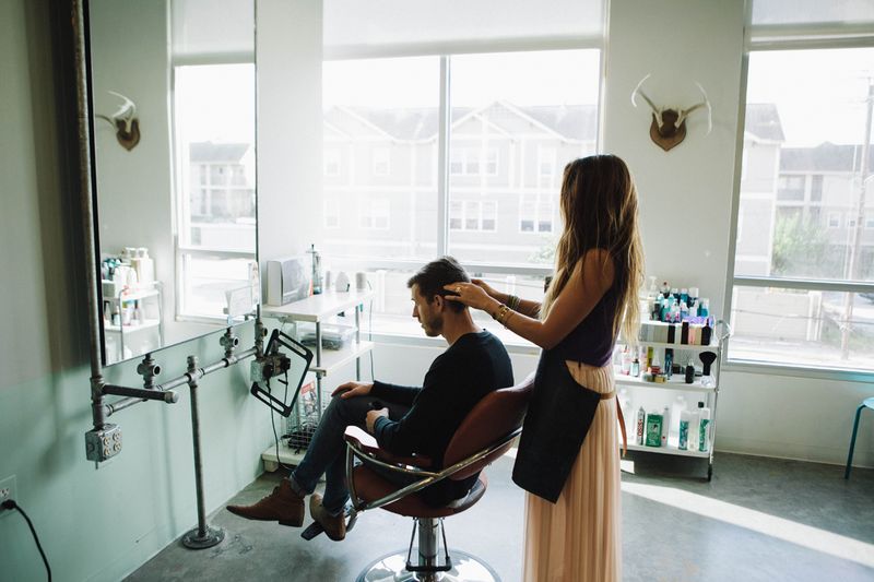 Do or Dye HTX stylist working with a seated client