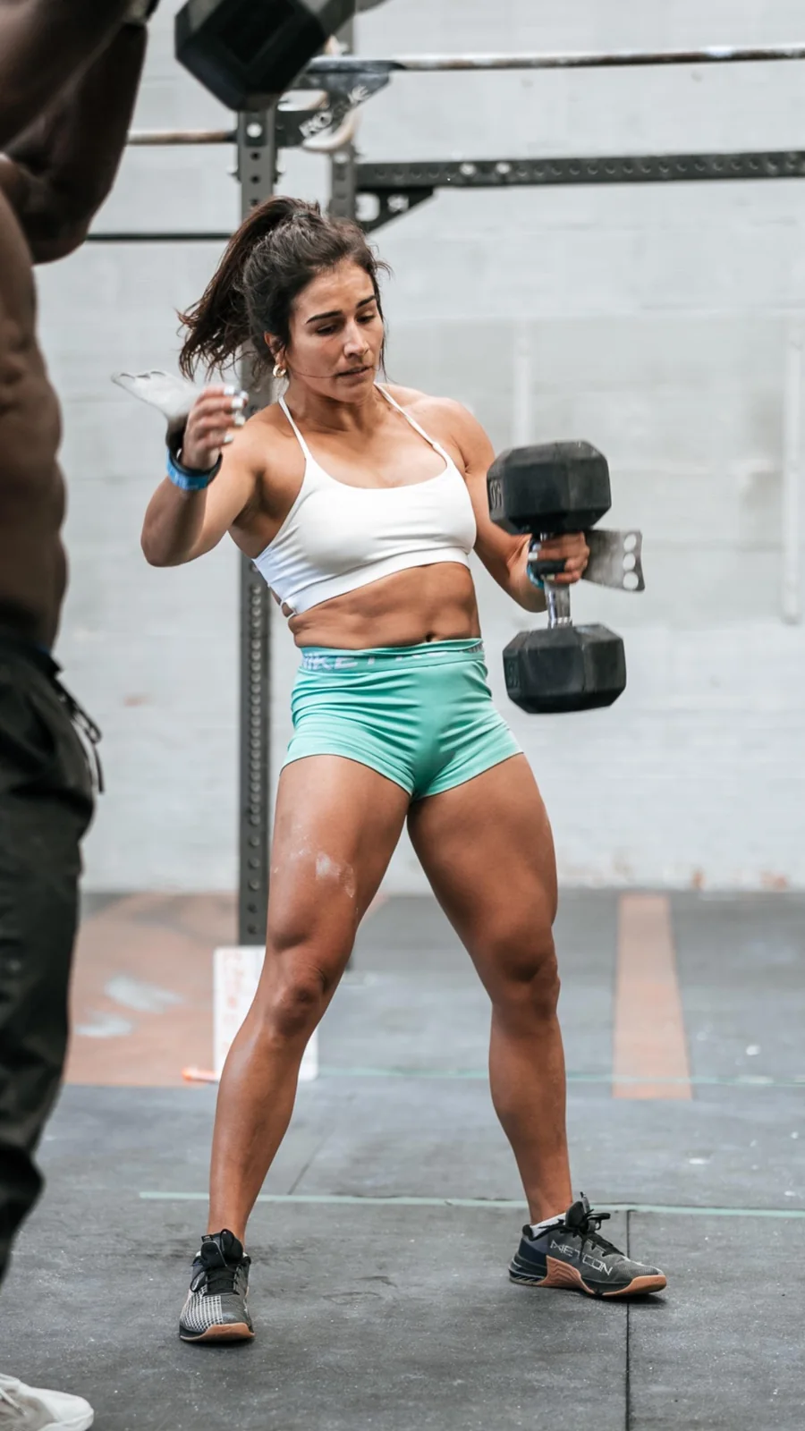 Lauren Fisher carrying dumbbells